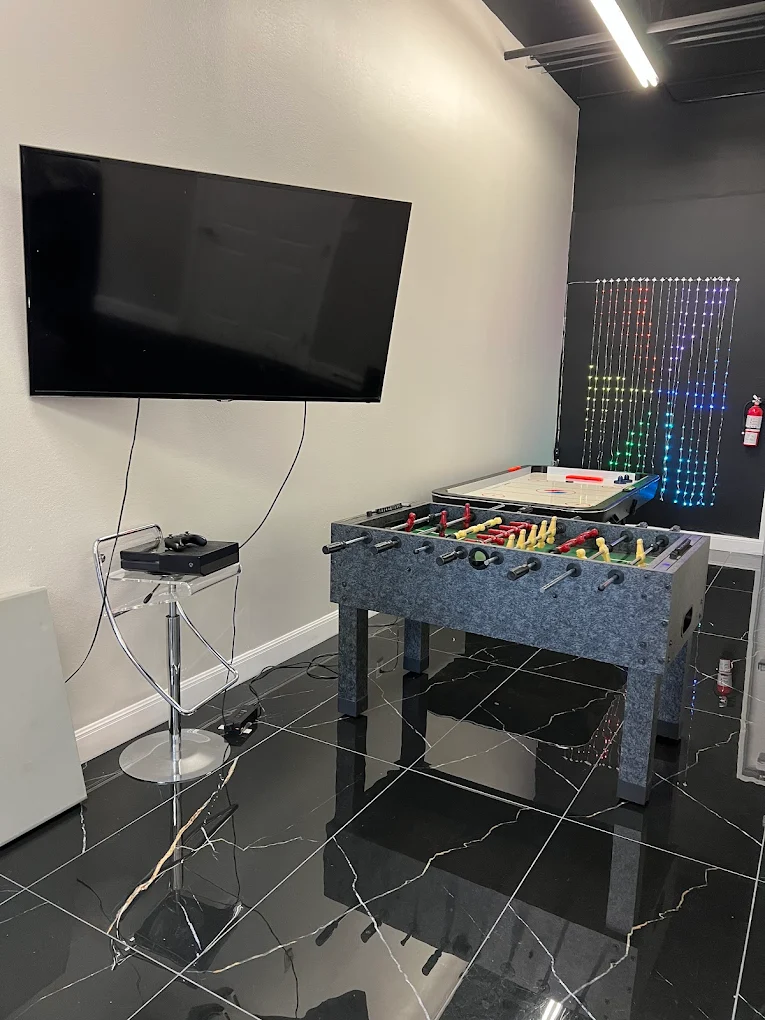 Foosball and air hockey tables in the Amari's Barbershop lounge