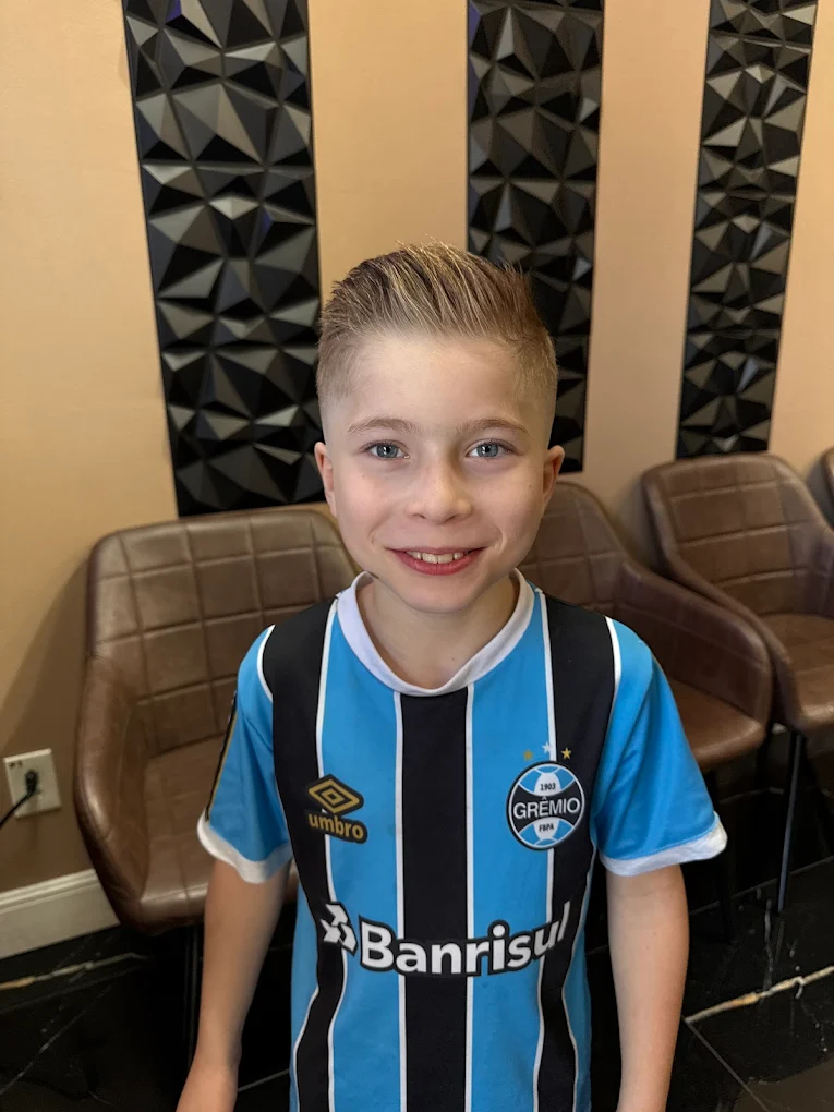 Smiling kid with finished haircut